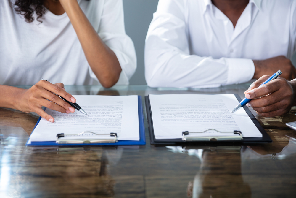 two,businesspeople,working,on,contract,paper,in,office