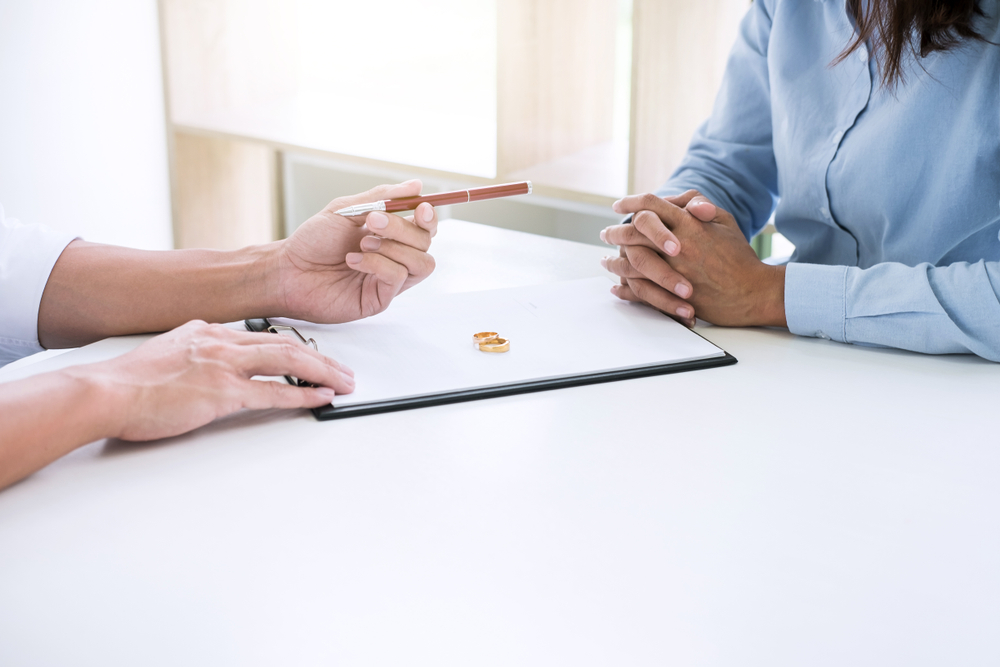 husband,and,wife,are,reading,divorce,agreement,and,filing,pen