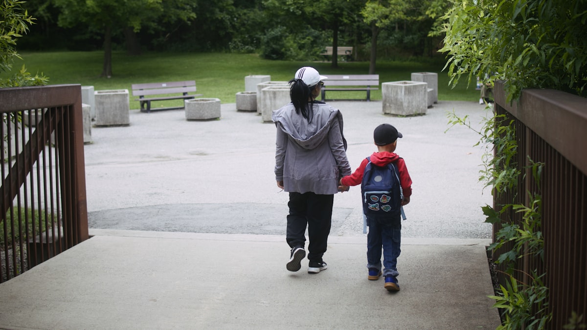 Parent and child walking in a park, co-parenting after divorce