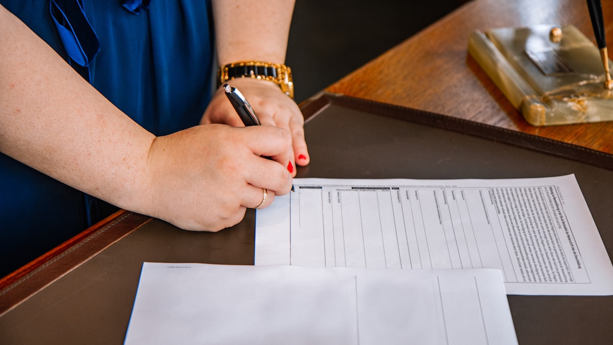 Hand signing divorce paperwork