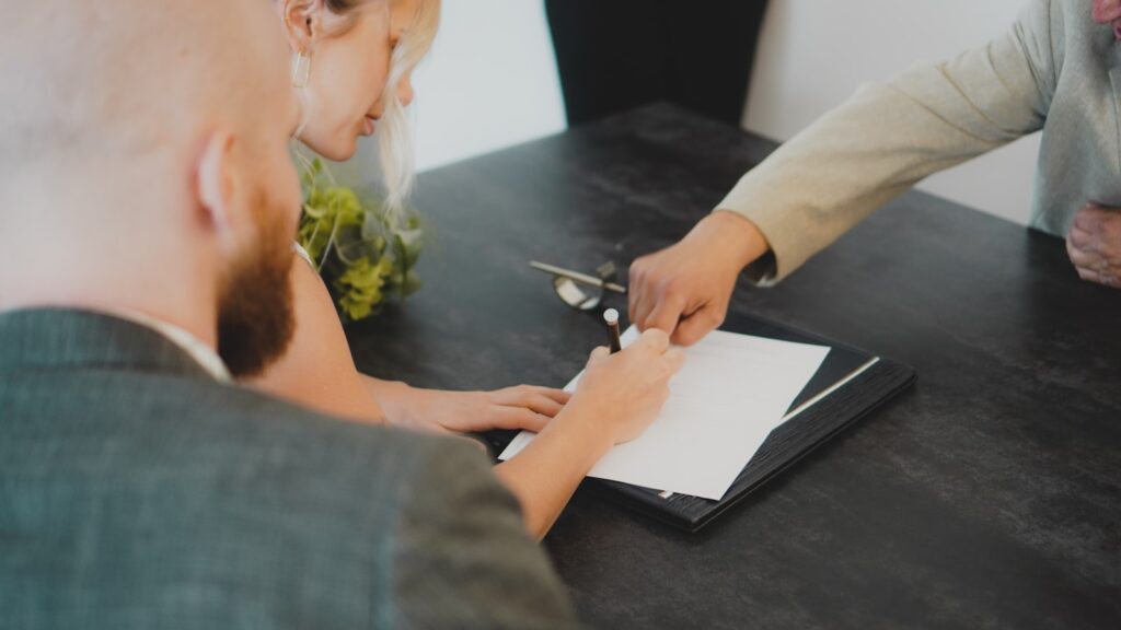 Couple signing an uncontested divorce agreement together